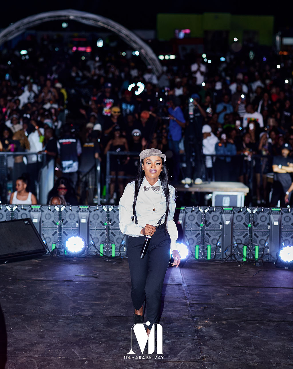 An artist on stage with the night-time crowd