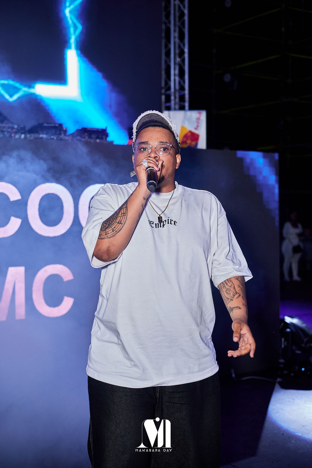 A vocalist under blue stage lights